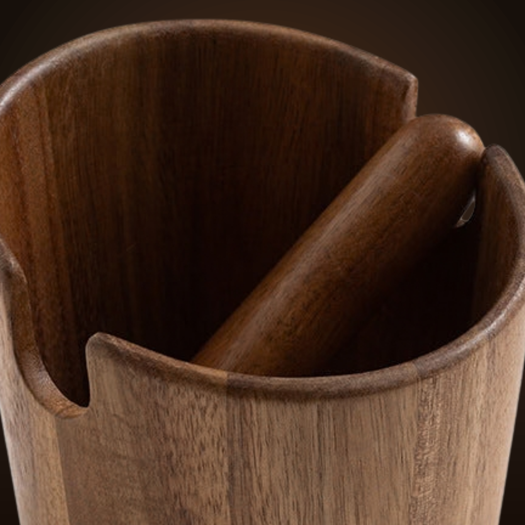Close-up of the rounded acacia knock bar resting in the rim notches of the knock box