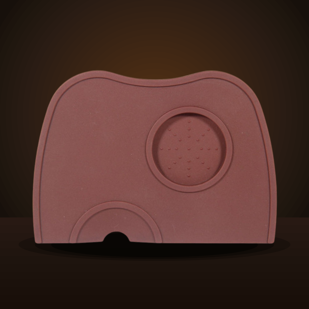 Silicone tamping mat in brown, top view on a dark studio backdrop